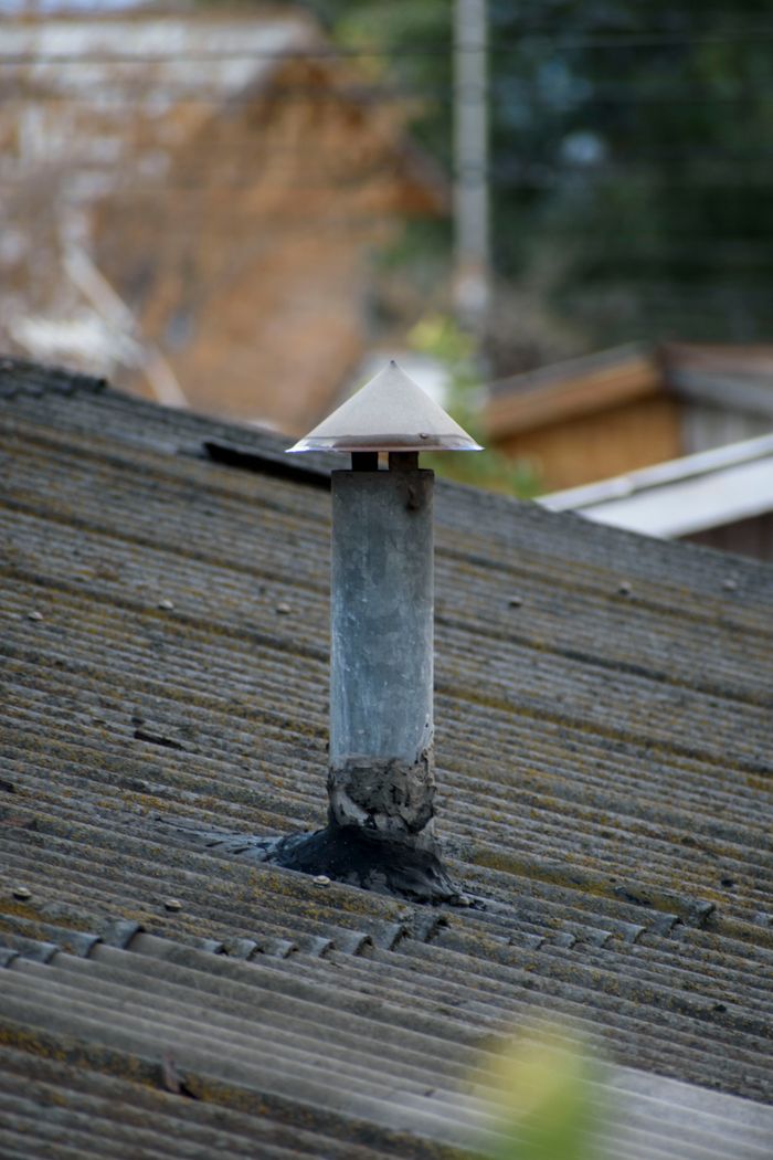 Close-up of a chimney vent on a rustic rooftop in La Granja, Chile.